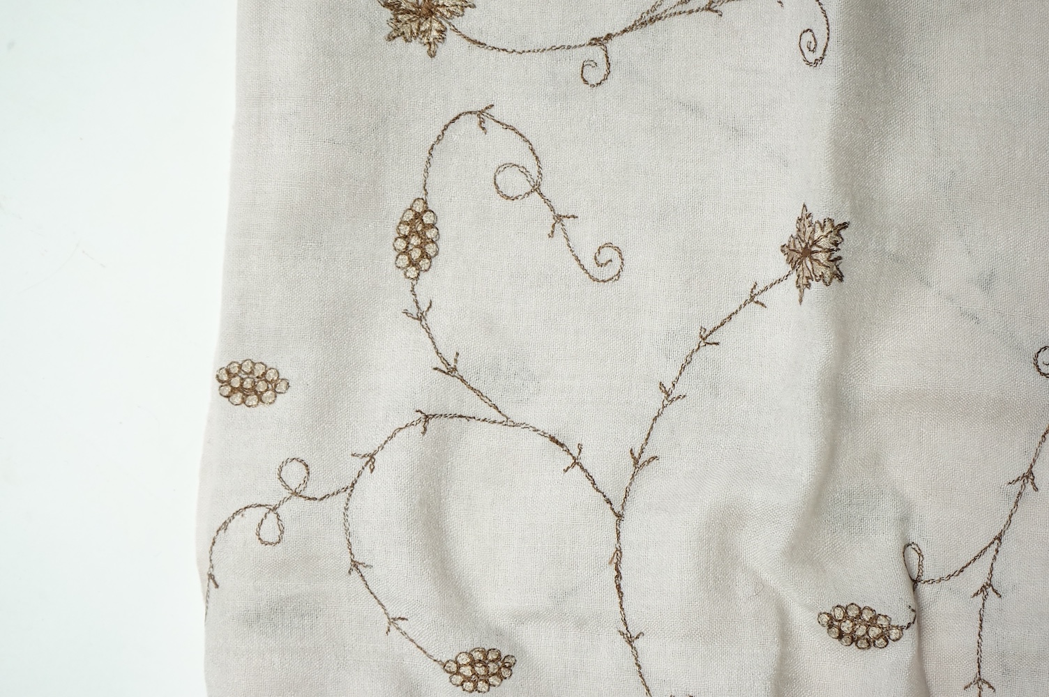 An Indian green and gold silk hand woven brocade stole, a cream pashmina embroidered stole and a similar finely woven and embroidered lilac stole (3). Brocade stole 38cm x 180cm., Condition - light stain to finely woven